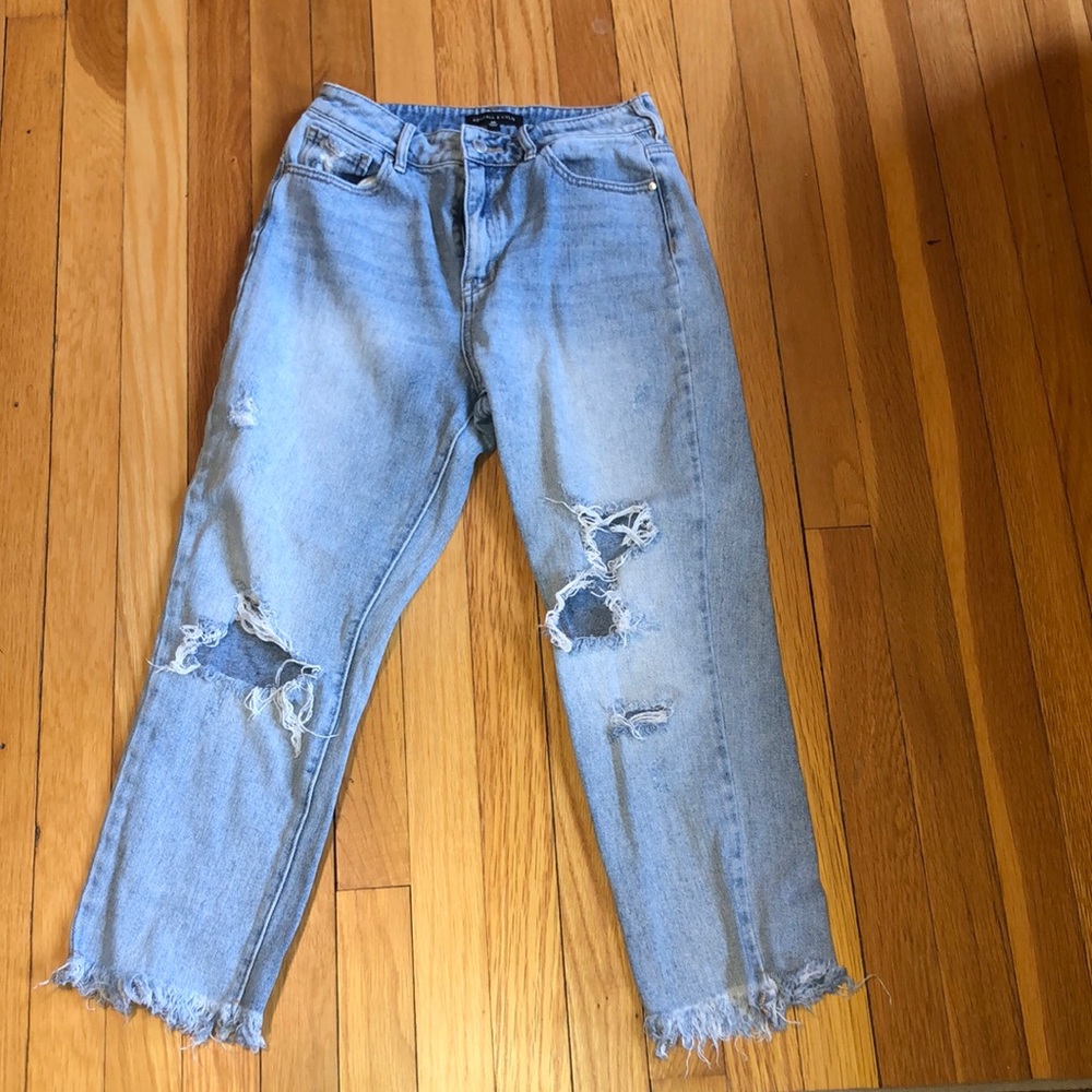Kendall and Kylie jeans with frayed bottoms and holes